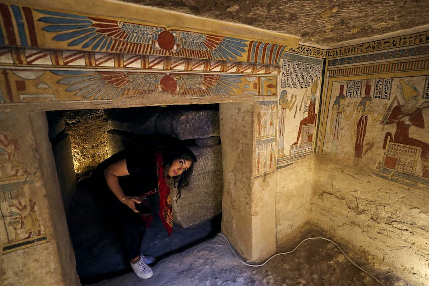 a tourist walks inside the tomb of tutu
