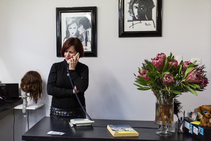 Hairdresser Gayle Emmett on the phone in her salon in Rupanyup in western Victoria.