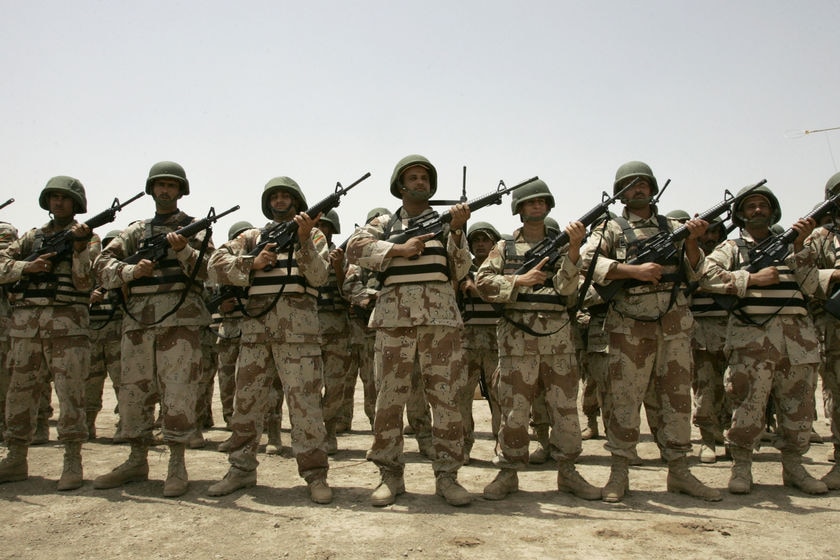 Iraqi soldiers hold their new rifles given by the US forces in the Taji US military camp in Baghdad.