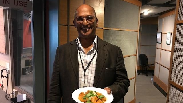 John Ger, chef and founder of Tamarind Tree Gourmet Sauces, with prawn masala dish he made.
