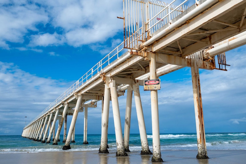 Tweed pumping jetty stretching out to sea - complete with barbed wire entry and DANGER sign.