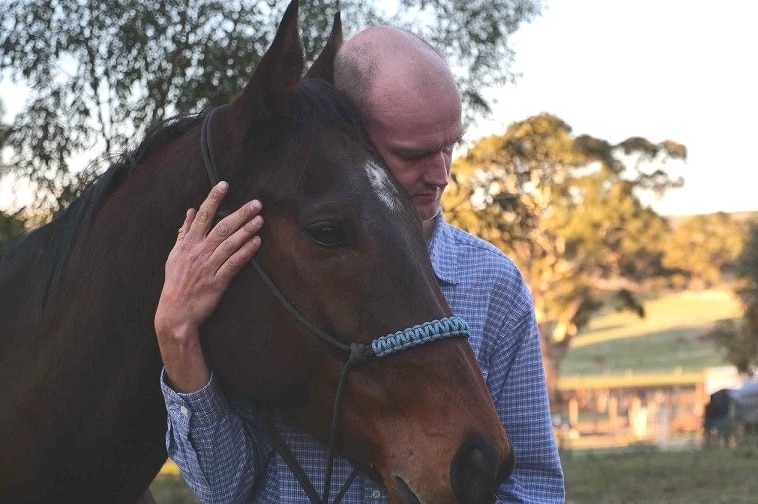 Windamere Horse Haven president David Mews with a former racing horse.