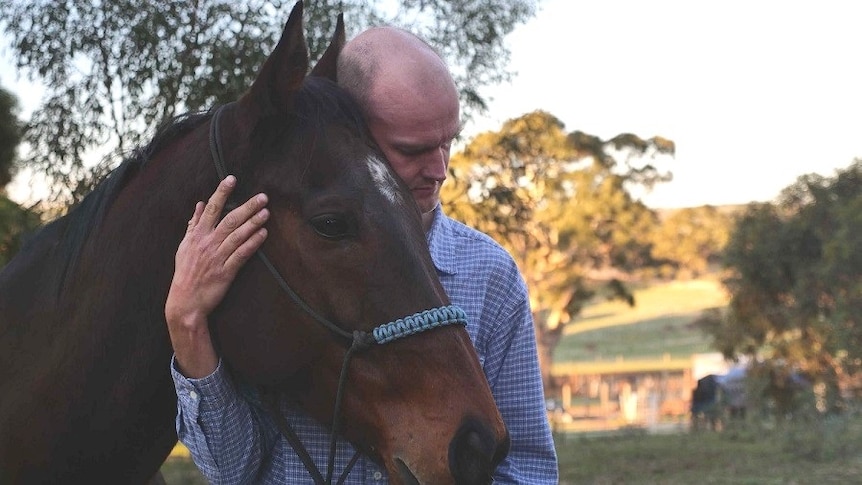 Windamere Horse Haven president David Mews with a former racing horse.