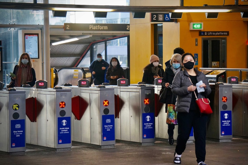 Commuters wearing masks at St Leonards station during Sydney's COVID-19 lockdown