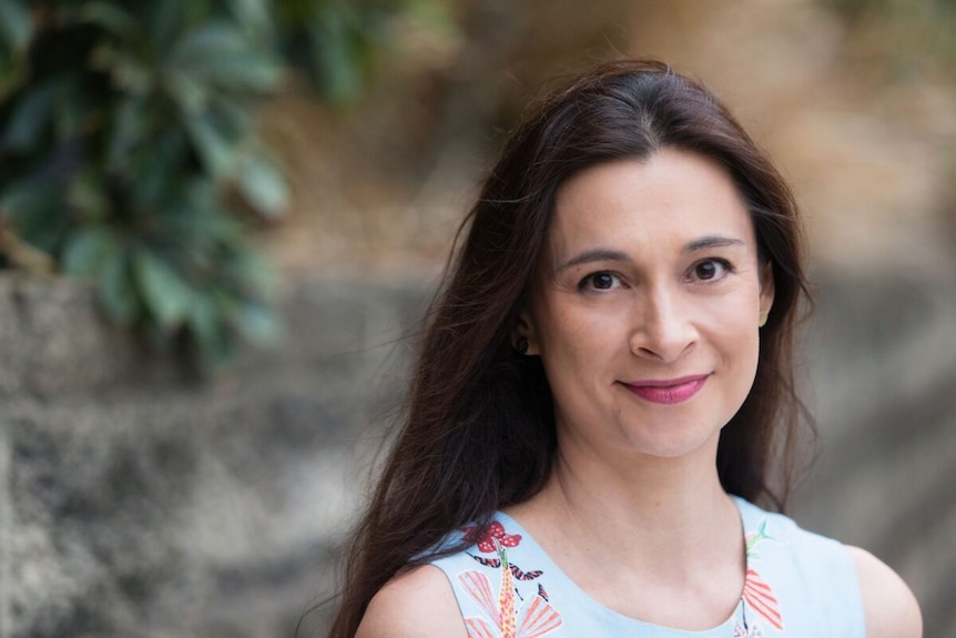 The author Mirandi Riwoe, a young woman with brunette hair, smiling