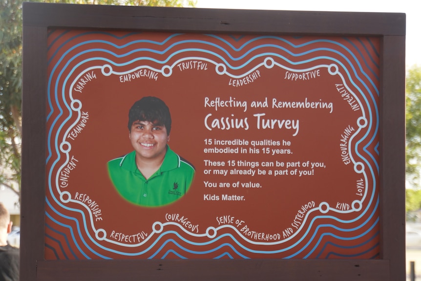 A brown plaque with the image of a boy on it, accompanied by text