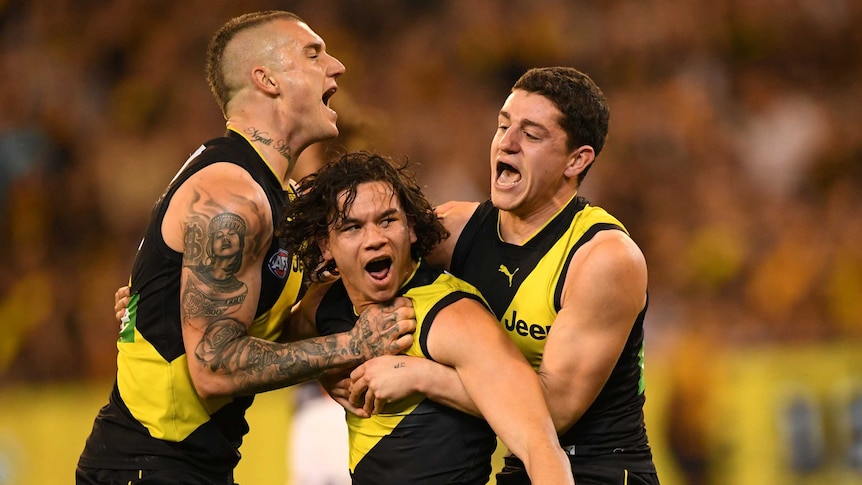 Dustin Martin, Daniel Rioli and Jason Castagna celebrate as a trio