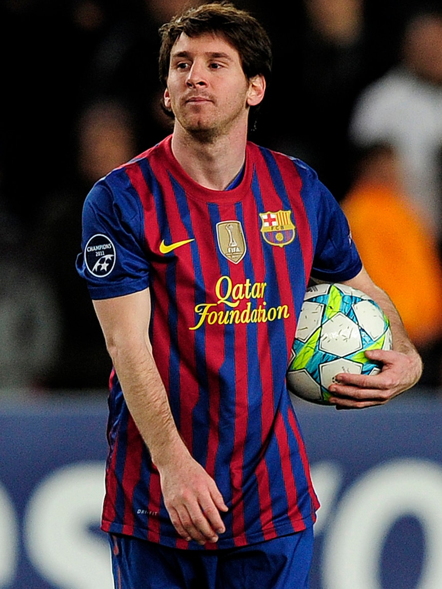 Lionel Messi walks off with the match ball