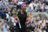 A tennis player screams and pumps his fist after winning a point at the US Open.