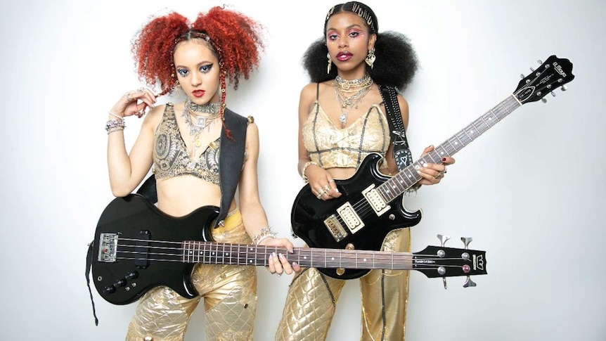 London rock duo Nova Twins, two women holding black guitars on a white background