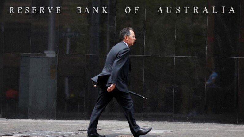 A businessman walks past the Reserve Bank of Australia in Sydney