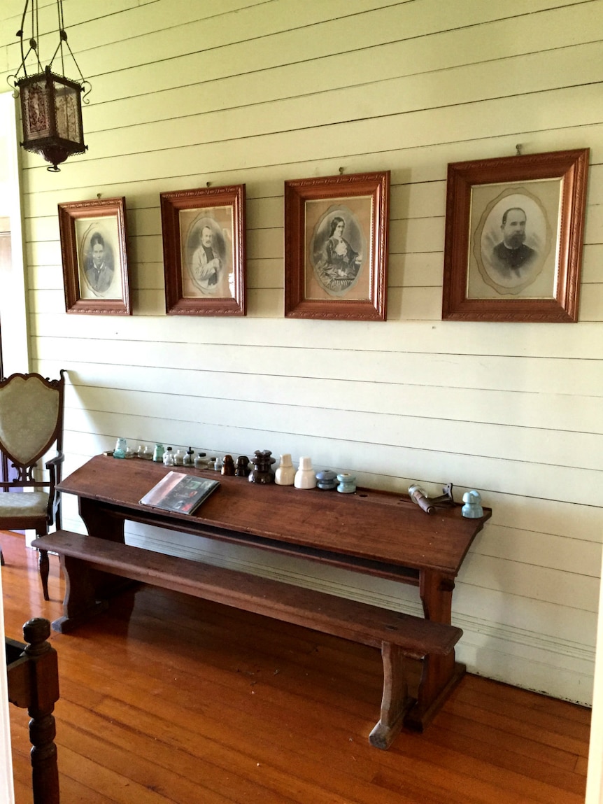 Hallways with portraits of the Wills family.