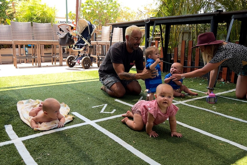 Parents and babies on a tiny mock-up race track