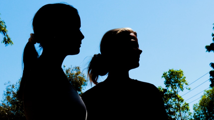 Two women in silhouette.