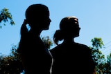 Two women in silhouette.