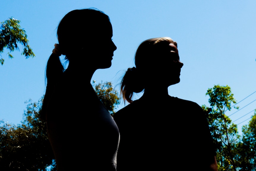 Two women in silhouette.