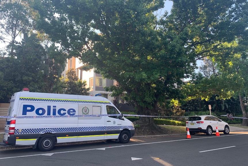 A police van outside an apartment block