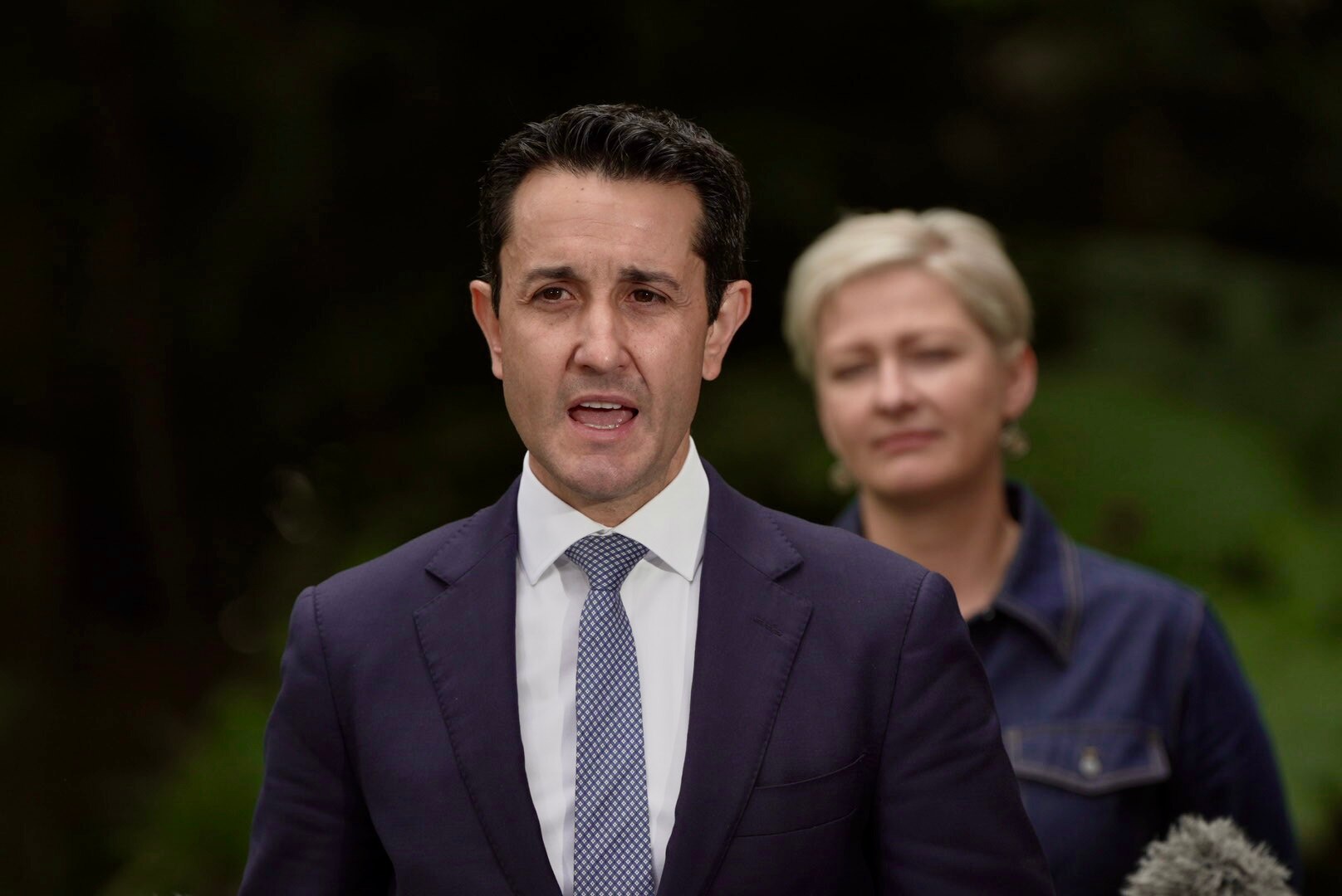 David Crisafulli speaks as Amanda Camm looks on in the background.