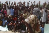 Somali men carry weapons during an demonstration organised by Al-Shabaab