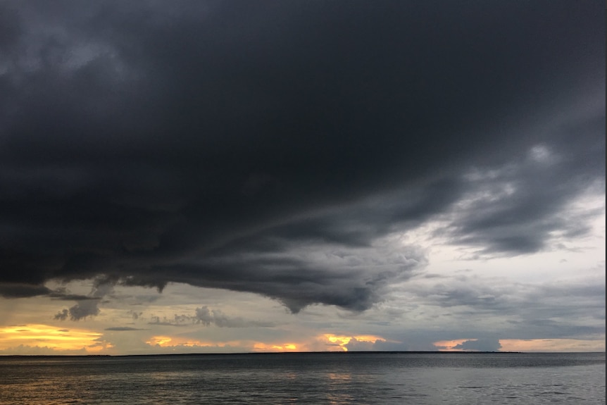 Storm clouds brewing over the water.