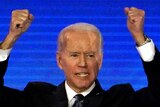 Democratic 2020 US presidential candidate former Vice President Joe Biden raises his hands