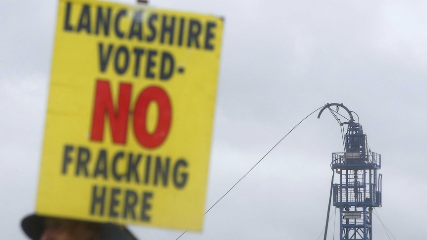 a Lancashire voted no fracking sign is held up near a fracking site