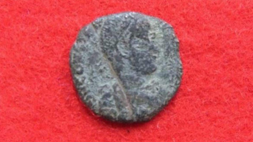 An ancient Roman coin believed to date back to 300- 400 AD, discovered by archaeologists on the site of a Japanese castle.