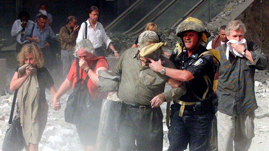 People walk away from the World Trade Centre towers