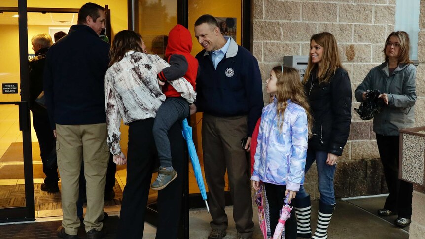 Republican Scott Perry stands in line and greets voters with withe children in Pennsylvania during US midterm elections.