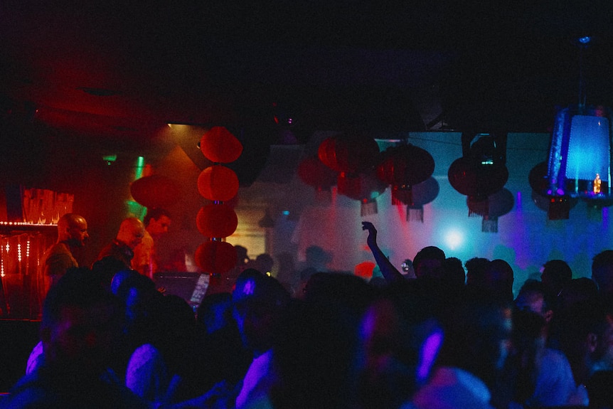 Crowd in the darkened nightclub Geisha Bar 