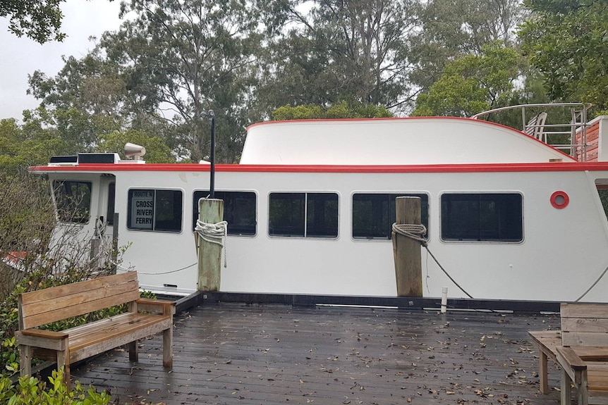 Ferry tied up to river pontoon