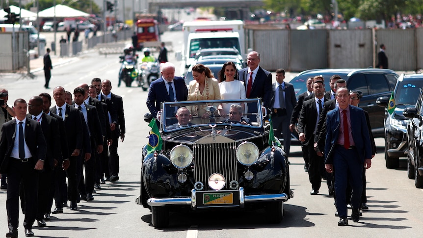 The motorcade of Brazil's President elect Luiz Inacio Lula da Silva with security lining either side.