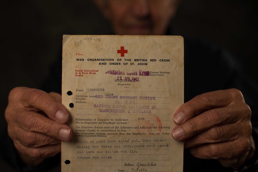 John Gruschka holding the last Red Cross letter he received from his mother Helene before she was murdered.