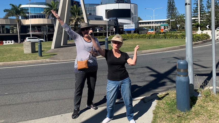 Two women dancing at the Queensland-NSW border.