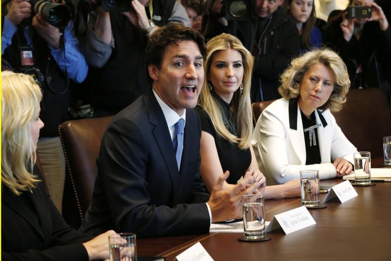 Justin Trudeau, Ivanka Trump (2nd R), Dawn Farrell (R) sit front and centre at the table, surrounded by press