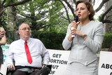 Jackie Trad speaks at a pro-choice rally with Rob Pyne beside her in his wheelchair.
