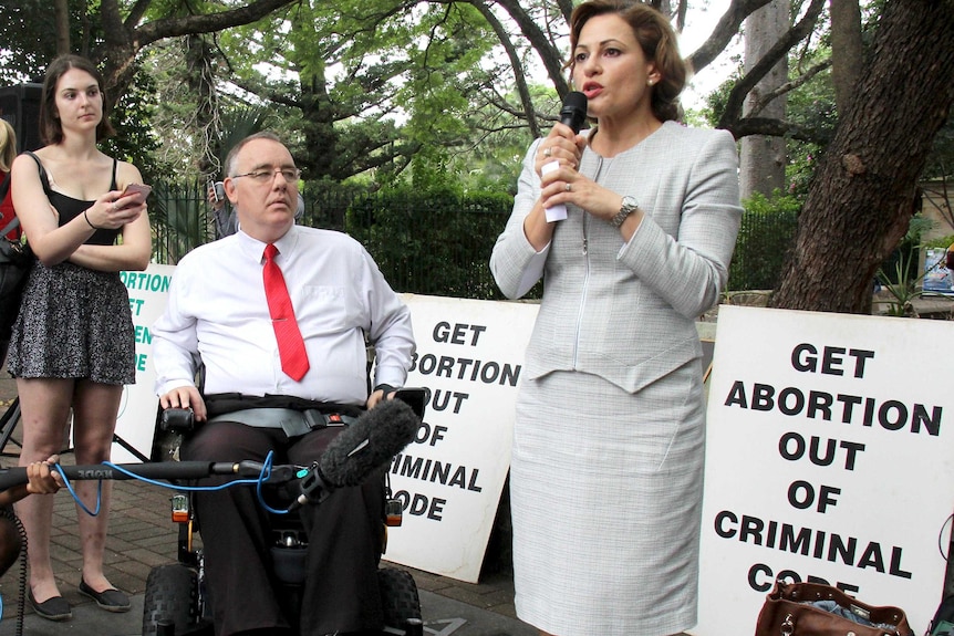 Jackie Trad speaks at a pro-choice rally with Rob Pyne beside her in his wheelchair.