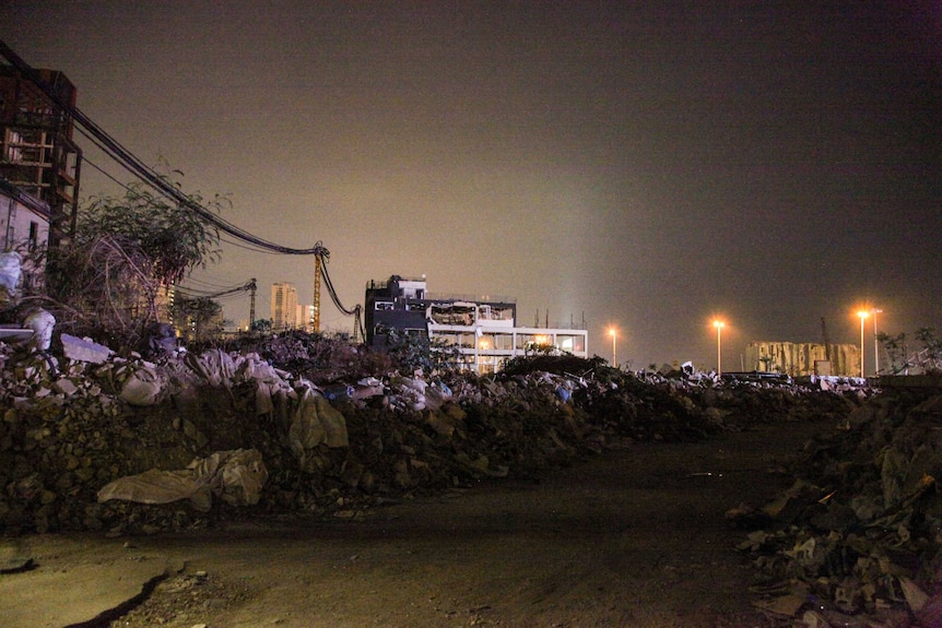 Piles of rubbles and destroyed buildings at night