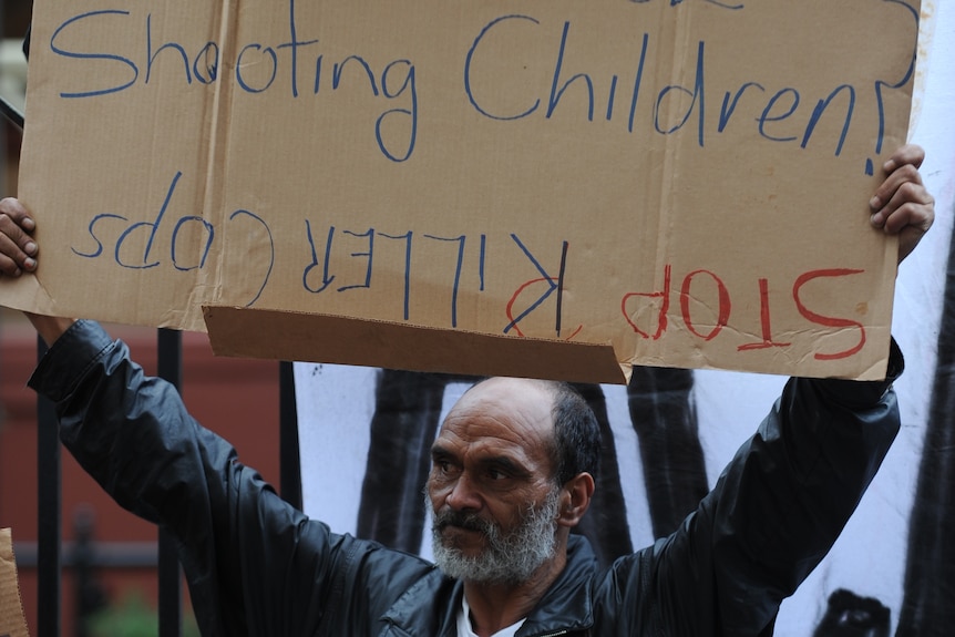 Man holds protest sign