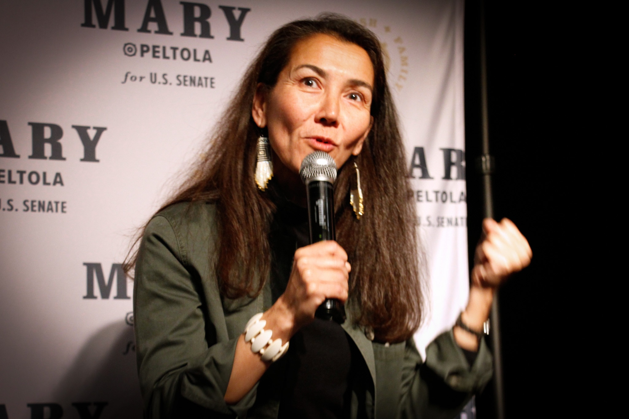 Mary Peltola speaks on stage while holding a microphone.