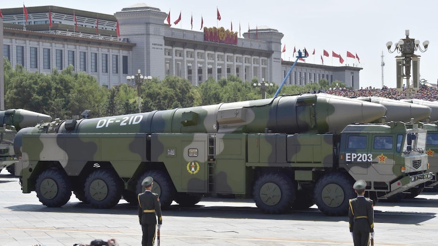 Image shows a missile loaded onto the back of a military vehicle on parade. 
