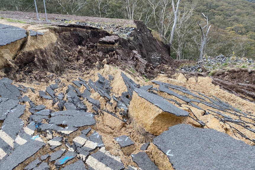 A landslip on a country road, showing bitumen atop chunks of gravel.