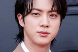 K-pop star Jin of BTS poses for a picture