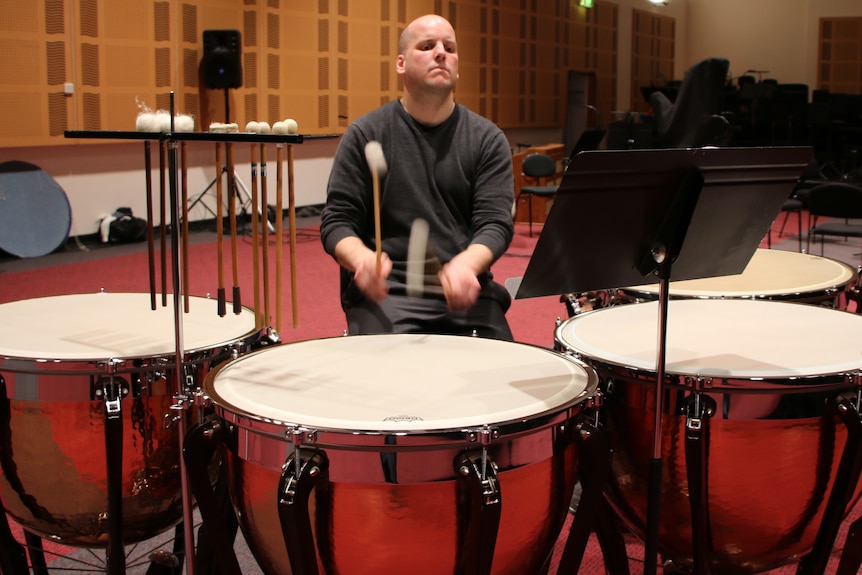 A man plays the drums