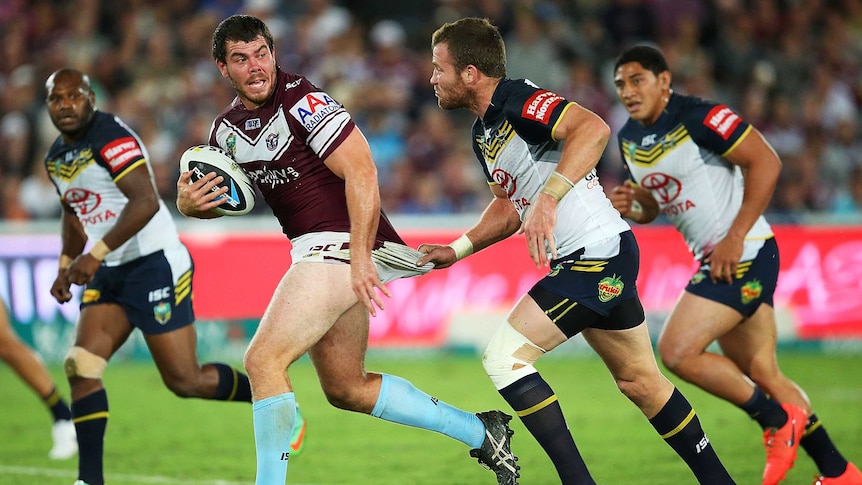 Josh Starling of Manly is held back