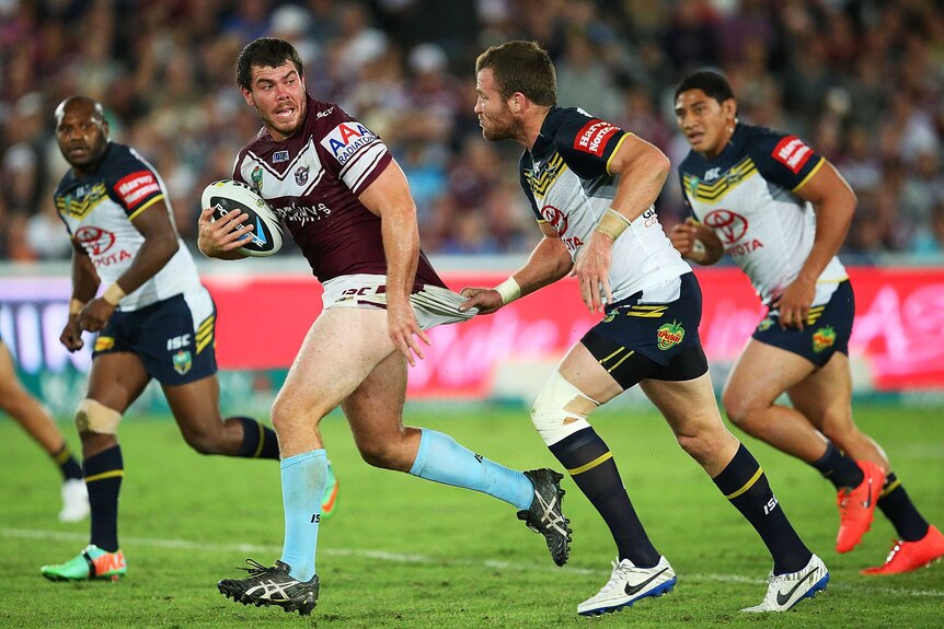 Josh Starling of Manly is held back