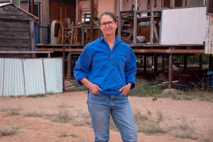 Rachael Webster standing in front of her house on her property north west of Longreach, November 2023. 