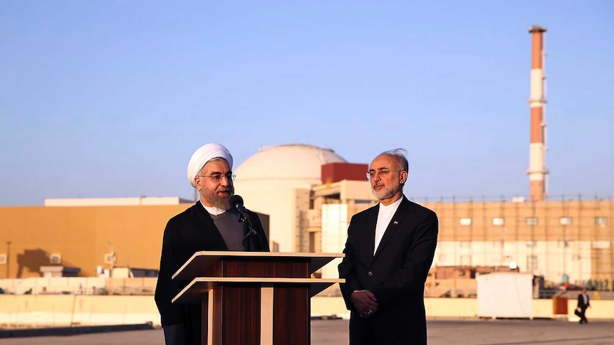 President Hassan Rouhani and Ali Akbar Salehi stand in front of the Bushehr nuclear power plant.