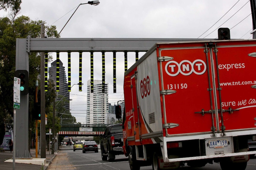 A truck approaching the height warning gantry before the Montague St bridge in Melbourne.