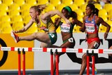 Sally Pearson clears a hurdle on her way to winning her heat